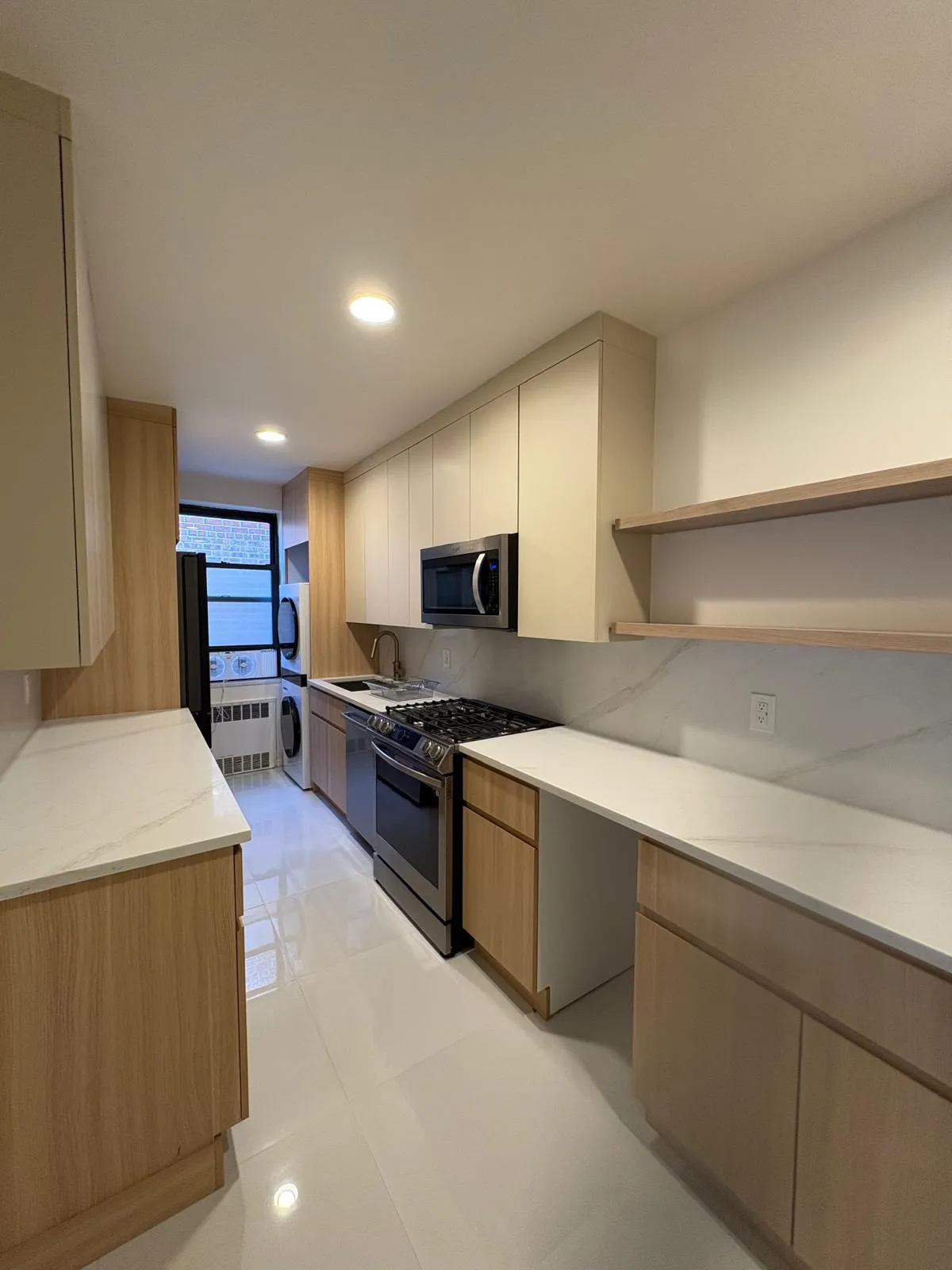 Renovated galley kitchen with custom wood cabinetry in Great Neck, New York