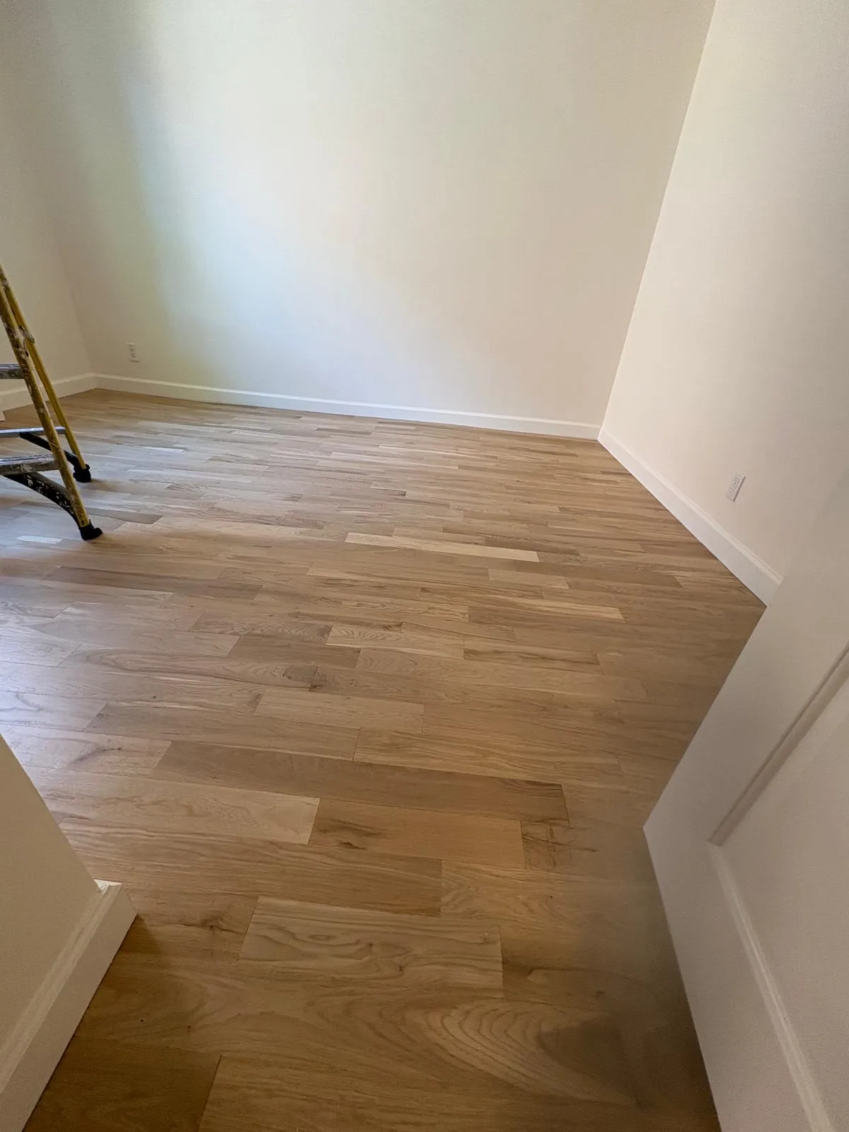 Detailed view of refinished hardwood flooring in the Great Neck apartment