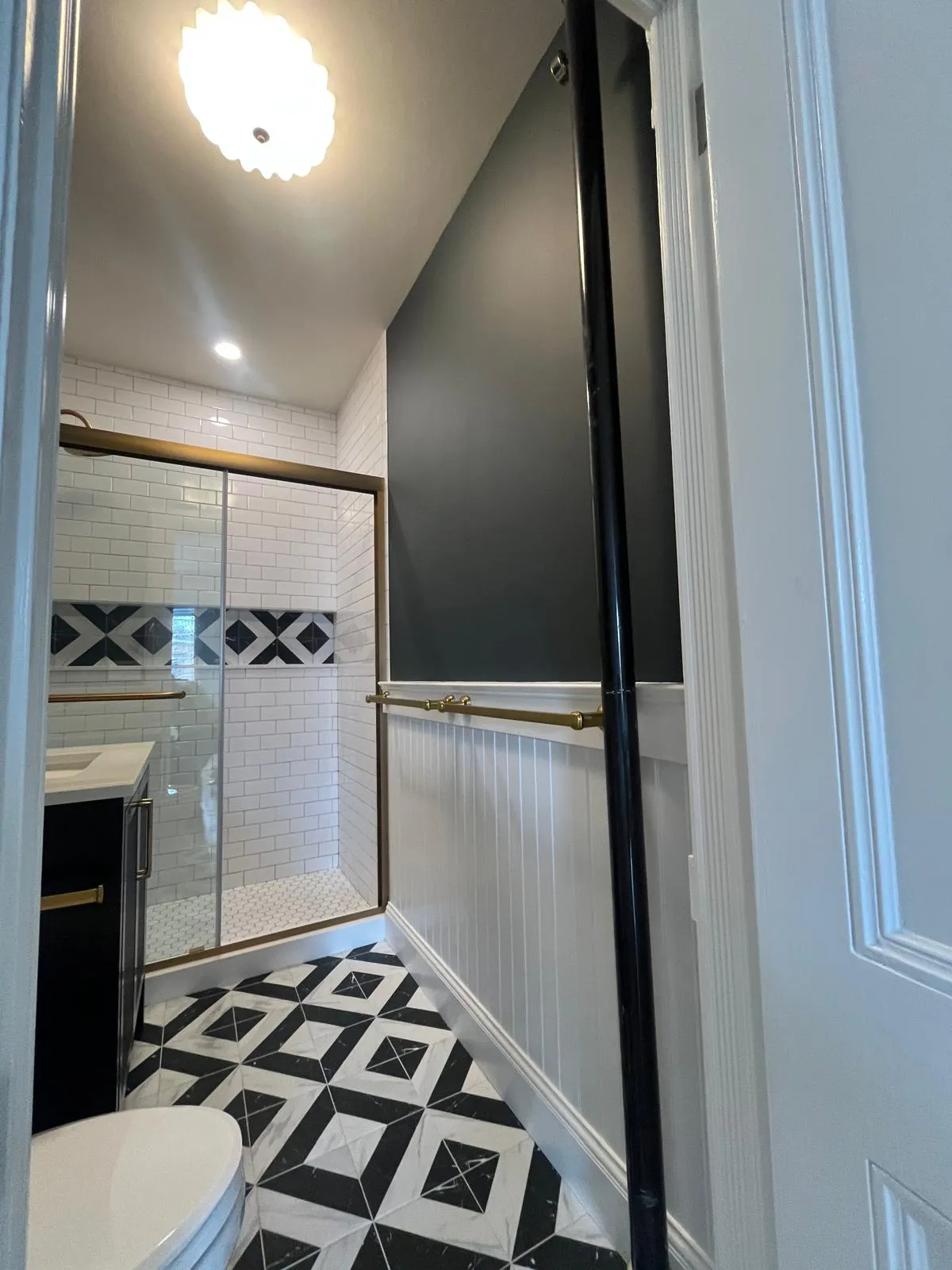 White wainscoting and brass towel rail in a Park Slope bathroom renovation